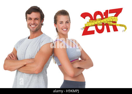 3D Composite image of portrait of a sporty young couple with arms crossed Stock Photo