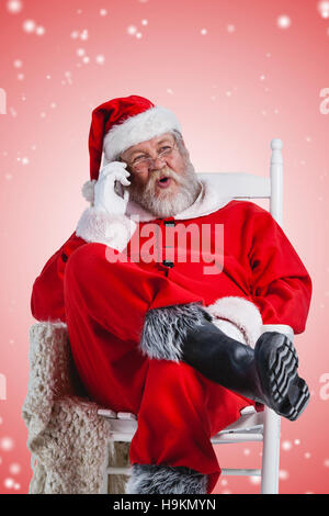 Composite image of excited santa claus talking on mobile phone Stock Photo