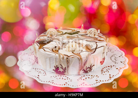 Appetizing pie with different chocolate ornaments on colorful brighting background Stock Photo