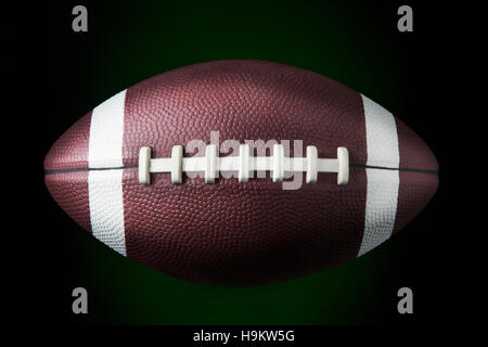 portrait of a american football ball in dark background Stock Photo