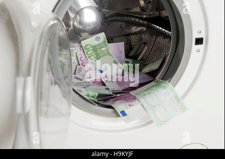 Euro banknotes in a washing machine, symbolic of money laundering Stock Photo