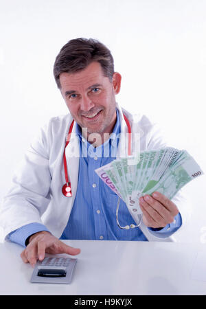 Doctor with a fan of banknotes and calculator, symbolic of doctor's remuneration Stock Photo