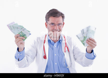 Doctor with fans of banknotes, symbolic of doctor's remuneration Stock Photo