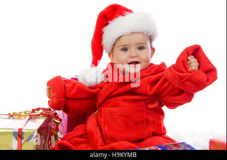 Toddler, 1 year, in Santa Claus costume with presents