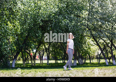 Young woman in blooming spring garden. Stock Photo