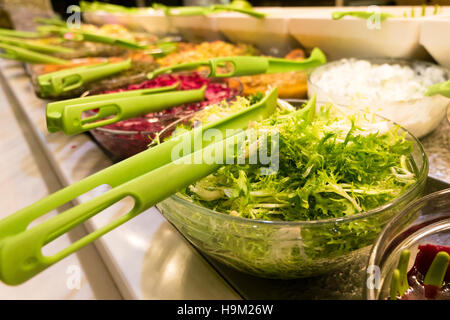 Salad bar with selective focus on the green veggie bowl Stock Photo