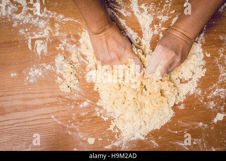 A woman kneading cake, bakery. Stock Photo