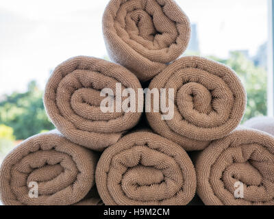 Pile of rolled up spa brown towel Stock Photo