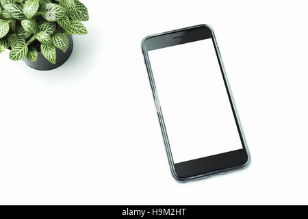 Smart phone and tree on White background. You can put in ads. Stock Photo