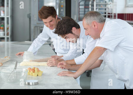 two generations in the laboratory of a bakery shop Stock Photo