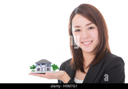 Real estate agent woman with house model Stock Photo