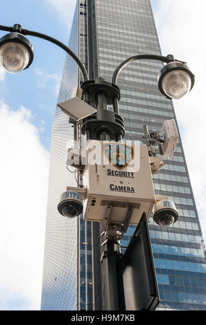 New York City Police street security cameras mounted in a pole with a skyscraper in the background / big brother is watching you Stock Photo