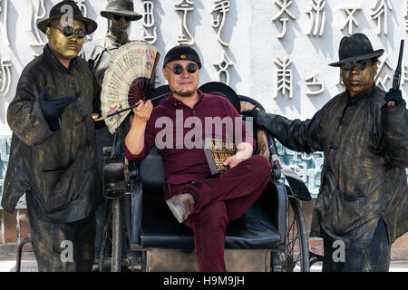 Chinese man posing for gangster portrait, Xian, China Stock Photo
