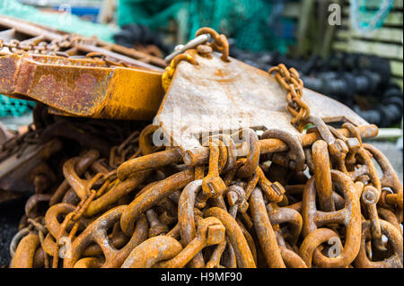 Rusty commercial fishing equipment pictured on the dock side/quay. Stock Photo