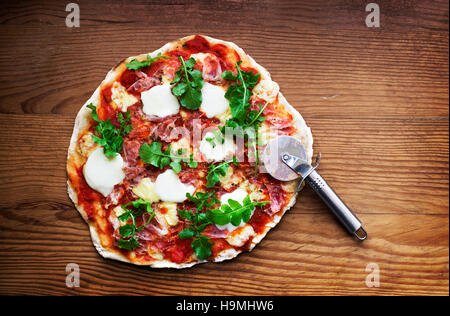 Delicious italian pizza served on wooden table Stock Photo