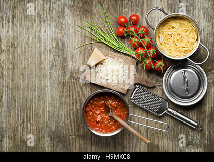 Pasta with bolognese sauce and parmesan cheese on wooden table Stock Photo