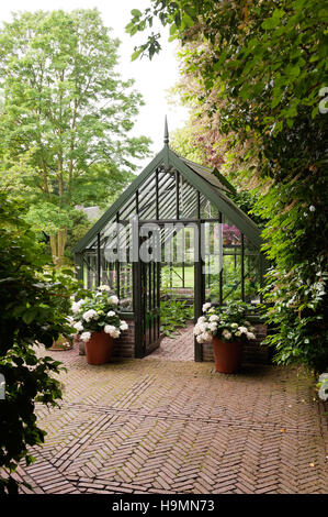 Greenhouse in grounds of German home Stock Photo