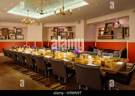Dining table and chairs in conference room at the Zetter hotel, Clerkenwell, London, UK Stock Photo