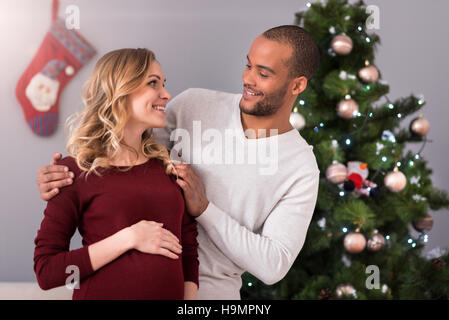 Loving happy husband looking at his pregnant wife Stock Photo