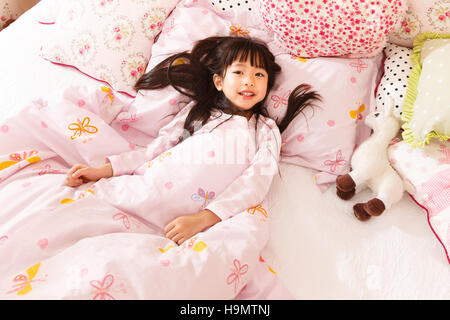 Cute little girl in bed Stock Photo