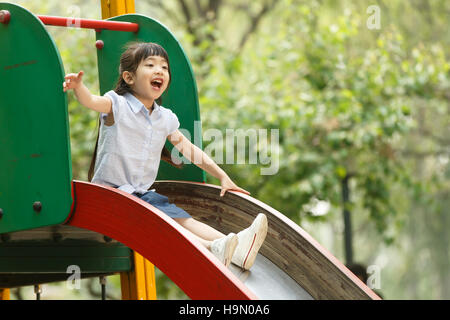 The little girl slide Stock Photo