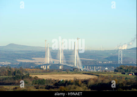 A view from West Lothian towards Fife showing the Queensferry Crossing under construction with the Forth Road Bridge, right. Stock Photo