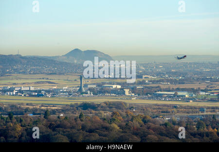 Aircraft taking off from Edinburgh Airport with the city of Edinburgh in the distance. Stock Photo