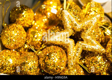 Many Christmas balls and star in golden sequins colorful xmas Background Stock Photo