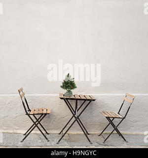 table and two chairs near the wall Stock Photo