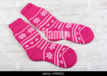 Pink woolen socks on white wooden background Stock Photo