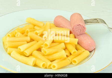 Eating Fast Food: Pasta with Sausage on Plate. Stock Photo