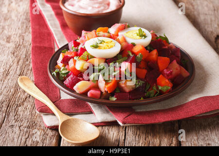 Finnish cuisine: rosolli salad of boiled vegetables and cream sauce close-up on the table. horizontal Stock Photo