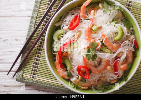 Thai salad with glass noodles, prawns and peanuts in a bowl close-up. horizontal view from above Stock Photo