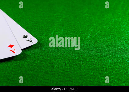 Two aces on the green felt casino table. Copy space on felt field Stock Photo
