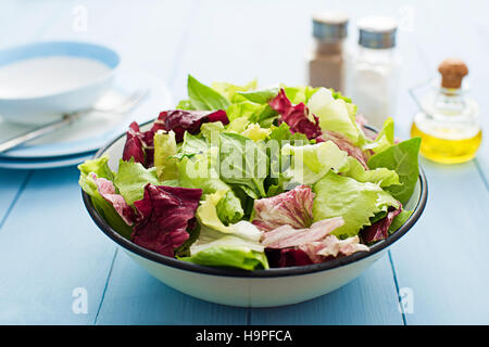 Fresh mixed green salad in a bowl close up Stock Photo