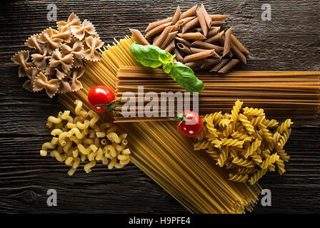 Raw pasta with basil and tomato overhead shoot Stock Photo