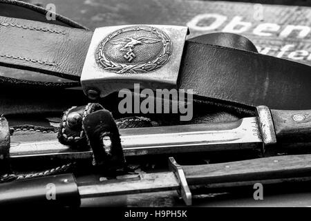 WWII German re-enactment equipment, including a belt and two knives including the Nazi Swastika. Stock Photo