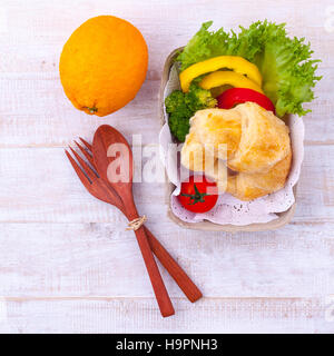 Clean food breakfast croissant and salad on wooden table. Stock Photo