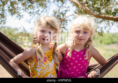 adorable smiling blond girl sitting in the net Stock Photo