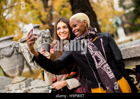 Young african american and caucasian women taking selfie outdoor Stock Photo