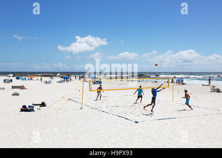 People playing beach volleyball on Camps Bay beach, Cape Town, South Africa Stock Photo
