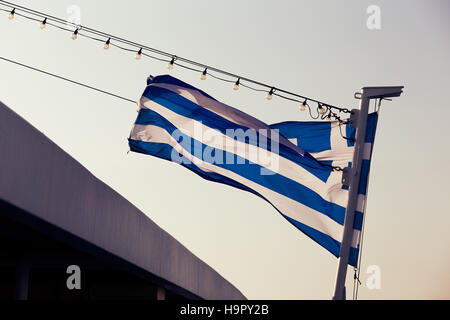 Greek flak waving in a post on the ferry Stock Photo