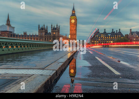 A reflection of Big Ben in a puddle on Westminster Bridge at dusk. Stock Photo