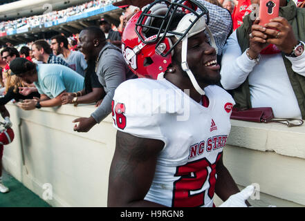 Chapel Hill, North Carolina, US. 25th Nov, 2016. Nov. 25, 2016 - Chapel Hill, N.C., USA - North Carolina State Wolfpack cornerback Nicholas Lacy (26) celebrates with Wolfpack fans after an NCAA football game between the North Carolina Tar Heels and the N.C. State Wolfpack at Kenan Memorial Stadium in Chapel Hill, N.C. N.C. State won the game 28-21. © Timothy L. Hale/ZUMA Wire/Alamy Live News Stock Photo