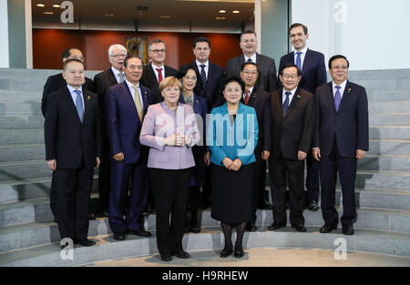 Berlin. 25th Nov, 2016. Chinese Vice Premier Liu Yandong (R F) and German Chancellor Angela Merkel (L F) pose for a photo with the representatives for the signing of the China-Germany football cooperation agreement in Berlin Nov. 25, 2016. China and Germany on Friday agreed to set up a high-level cultural exchange mechanism. © Shan Yuqi/Xinhua/Alamy Live News Stock Photo
