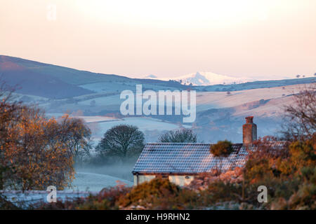 A frozen landscape over the Flintshire landcape with the Clwydian Range in the distance and the snow capped mountains of Snowdonia in the far distance Stock Photo