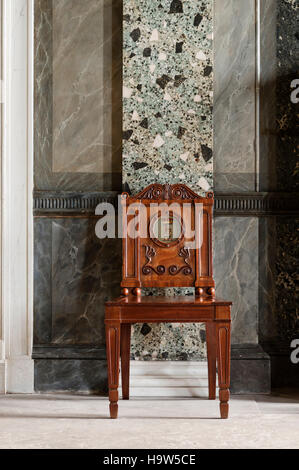 Detail of the scagliola pilasters and a mahogany hall-chair in the Entrance Hall at Attingham Park, Shropshire. Stock Photo