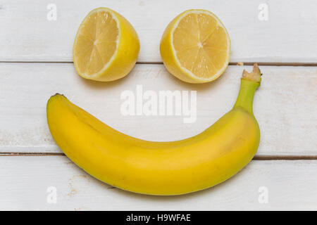 Fruits set as a smiling face isolated on the table Stock Photo