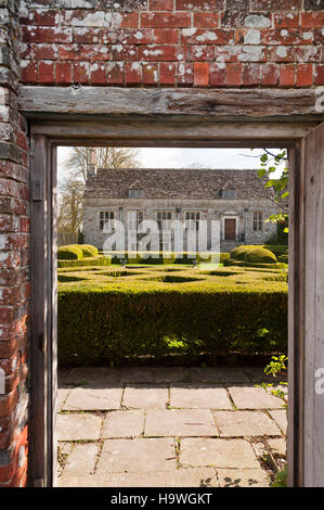 View over hedging towards the west front at Avebury Manor, Wiltshire. Stock Photo