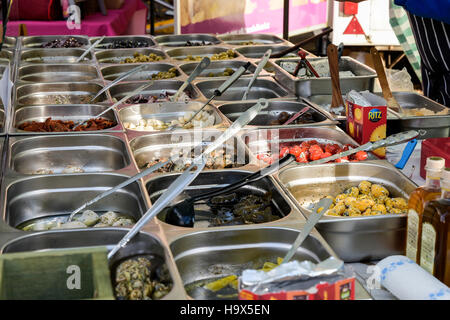 Stainless steel containers with food on market stall Derbyshire England Stock Photo